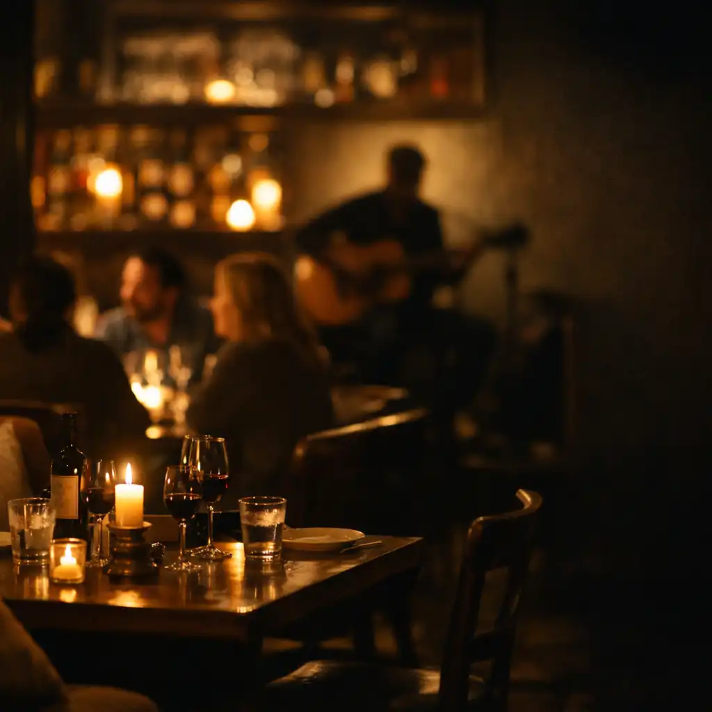 Intimate candlelit dining room with distant acoustic musician
